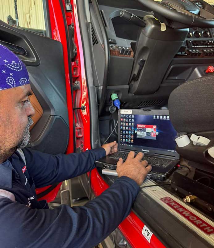 A TBM Carriers company driver working the onboard computer in the cab
